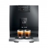 Machine espresso noire marque JURA vu de face avec deux tasses de café